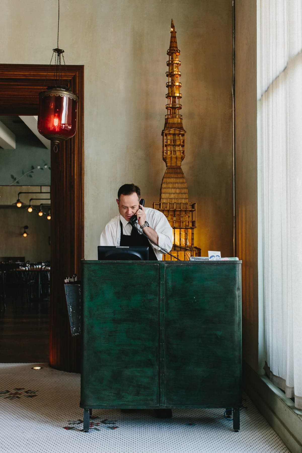 Restaurant host handling customer calls